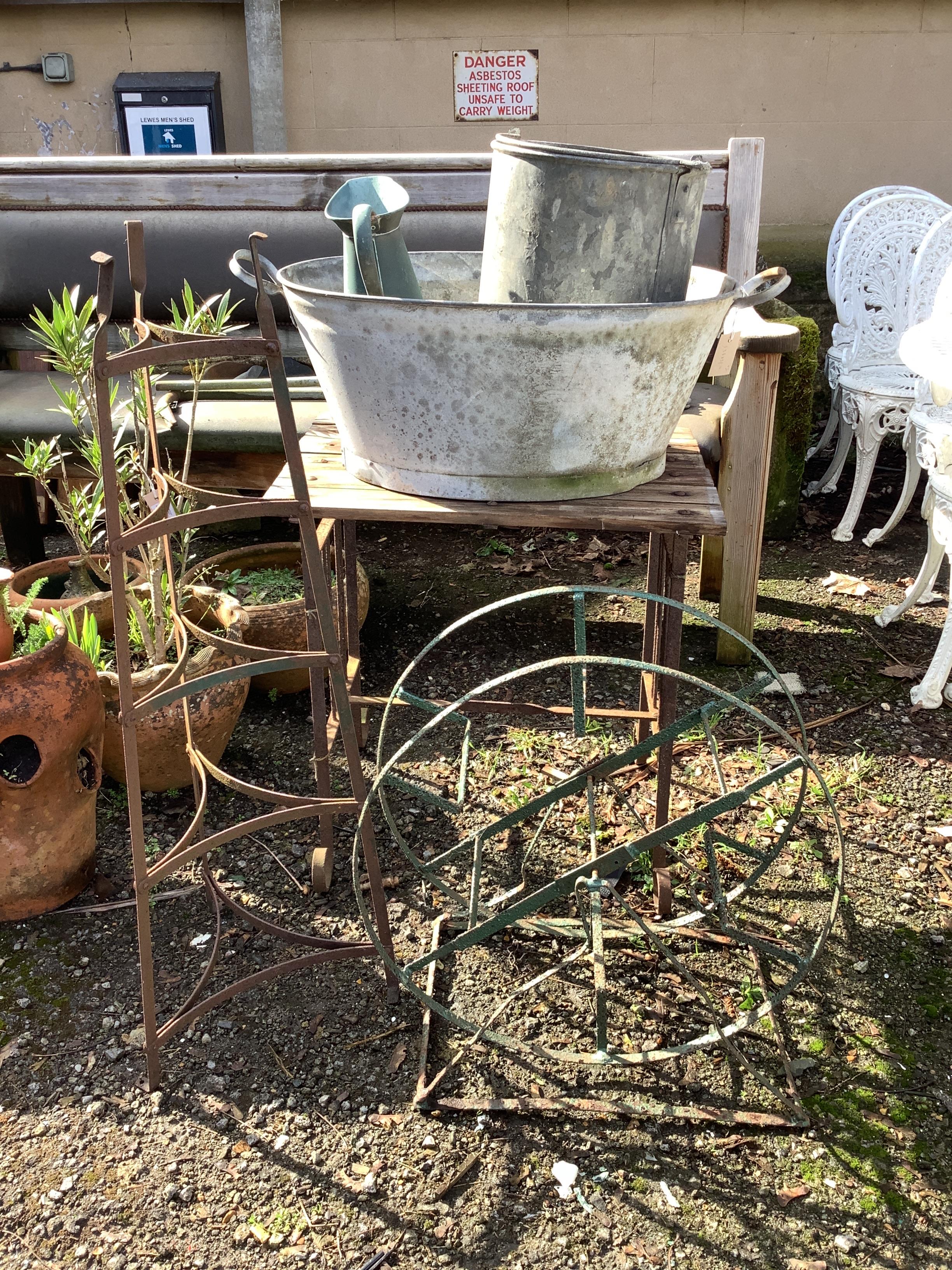Two galvanised containers, a wrought iron pot stand, garden table, etc.